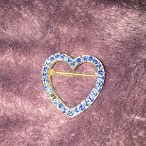a heart pin, one of the rhinestones are missing
